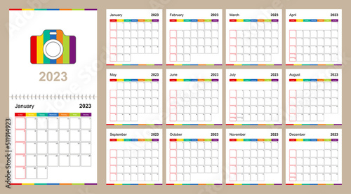 Colorful wall calendar for 2023 on beige background, week starts on Sunday.