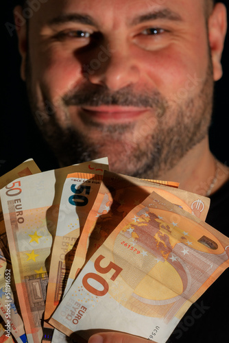 closeup of a man's facial expression of greed