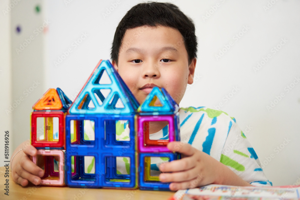 asia boy make house from plastic block toy in construct concept asia boy make house from plastic block toy in construct concept