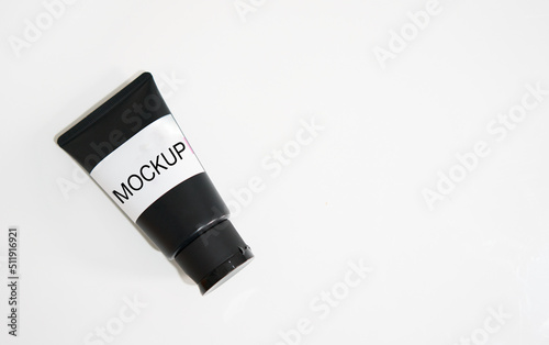 black cosmetic mockup cream tube on white with label