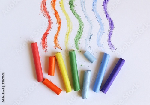 Multi-colored pastel crayons on a white background. Rainbow Colors. Art materials for school and hobbies. photo