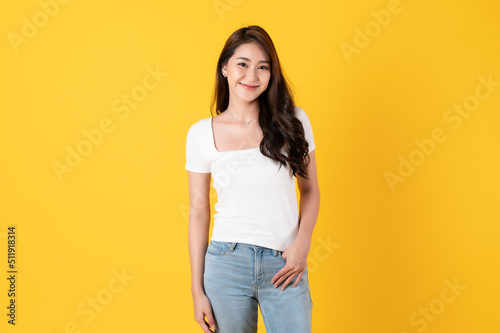 Smiling asian woman white shirt on yellow background