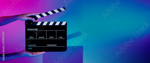 Movie Clapper board. Crew hand holding plastic and wooden film slate board against camera. Movie clapperboard using in video production and movie studio works film industry. Film slate on crew hand.