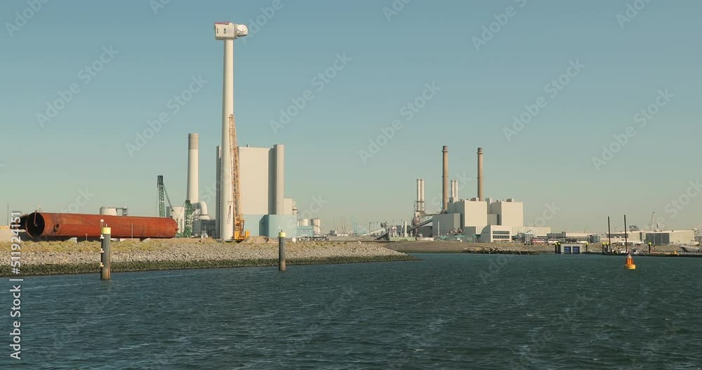 Power plant with modern building structue and wind turbine