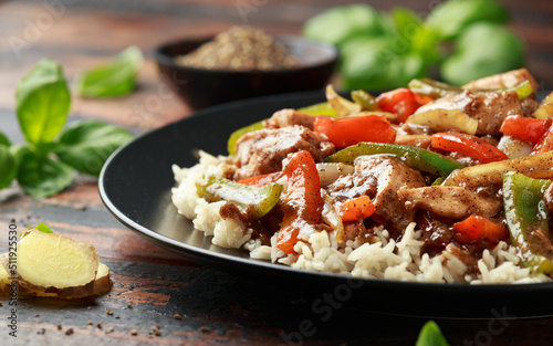 Stir fry pepper chicken with sweet peppers, onion, garlic and ginger