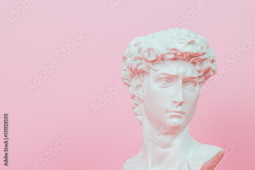 Plaster figure on a light pink background. Abstract background. Minimal concept.