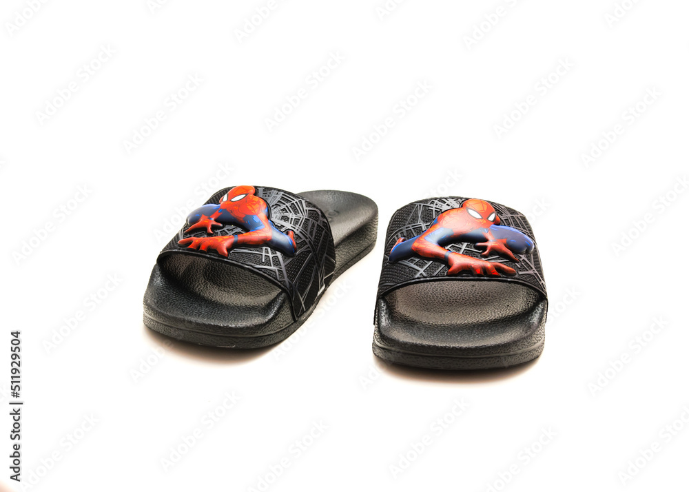 Fototapeta premium Pair of adilette shower slides sandal style with an open toe and print design of Spiderman from Adidas isolated on white background