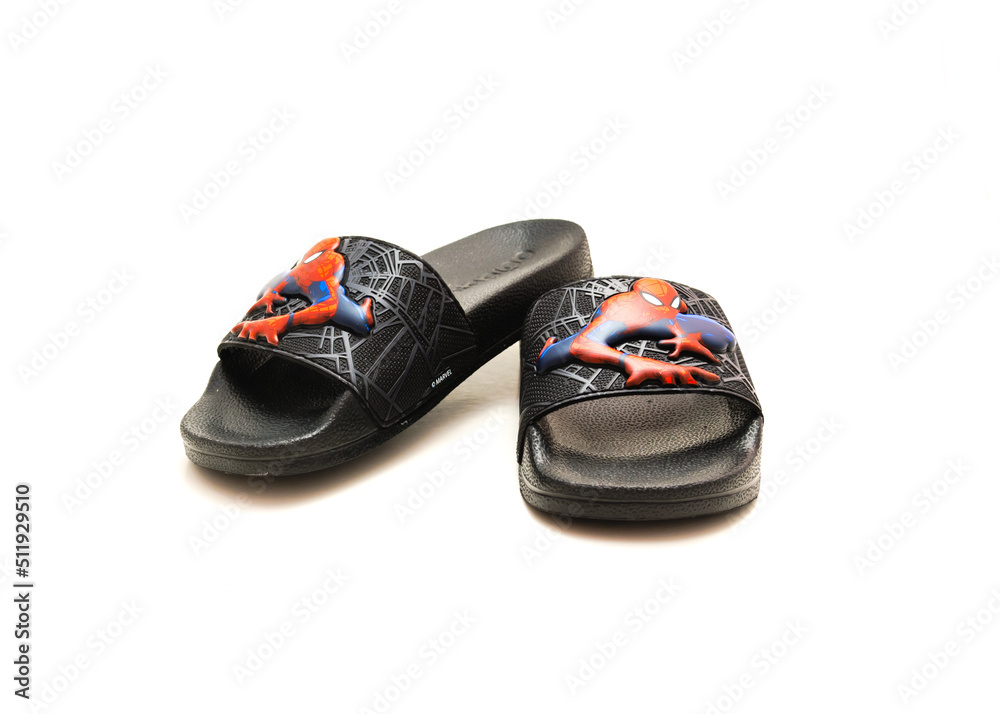Fototapeta premium Pair of adilette shower slides sandal style with an open toe and print design of Spiderman from Adidas isolated on white background