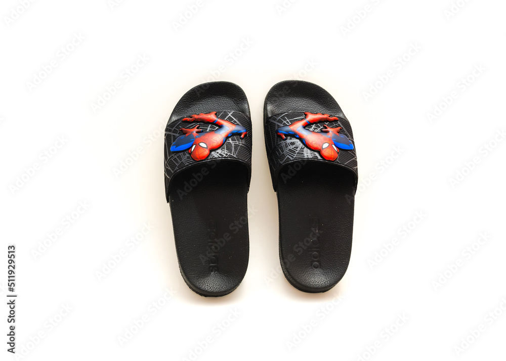 Obraz premium Pair of adilette shower slides sandal style with an open toe and print design of Spiderman from Adidas isolated on white background