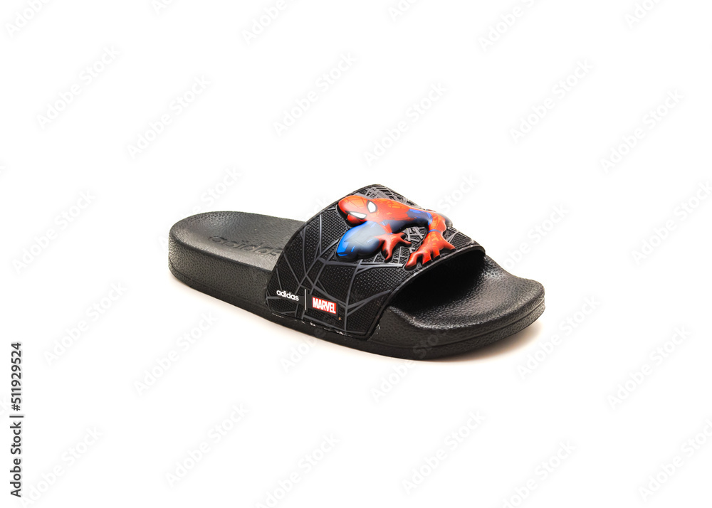Obraz premium Single adilette shower slides sandal style with an open toe and print design of Spiderman from Adidas isolated on white background