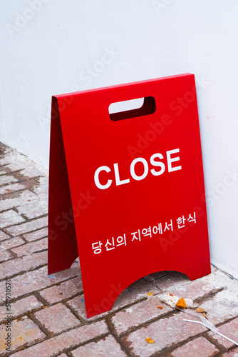 CLOSED sign board on street at korean restaurant. © wanatithan