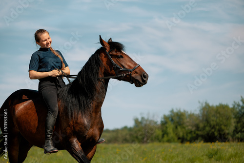 Canvas Print Smiling woman training young horse in field