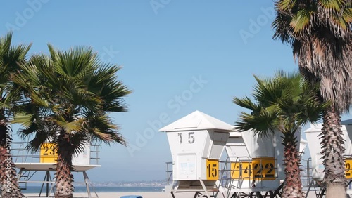 Lifeguard stand and palm tree, life guard tower for surfing on California beach. Summer pacific ocean in USA aesthetic. Iconic rescue baywatch station, coast lifesavers wachtower hut or house by sea.