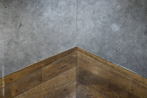 The junction of natural stone and wooden floor High-quality close-up photo