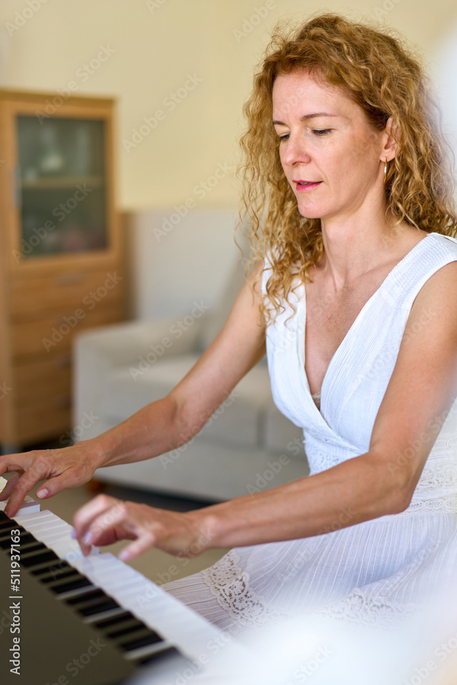 Woman in white dress sitting at the piano. Woman playing piano were digitally modified. Practice at home. Woman in white dress sitting at the piano. Woman playing piano were digitally modified. Practice at home.