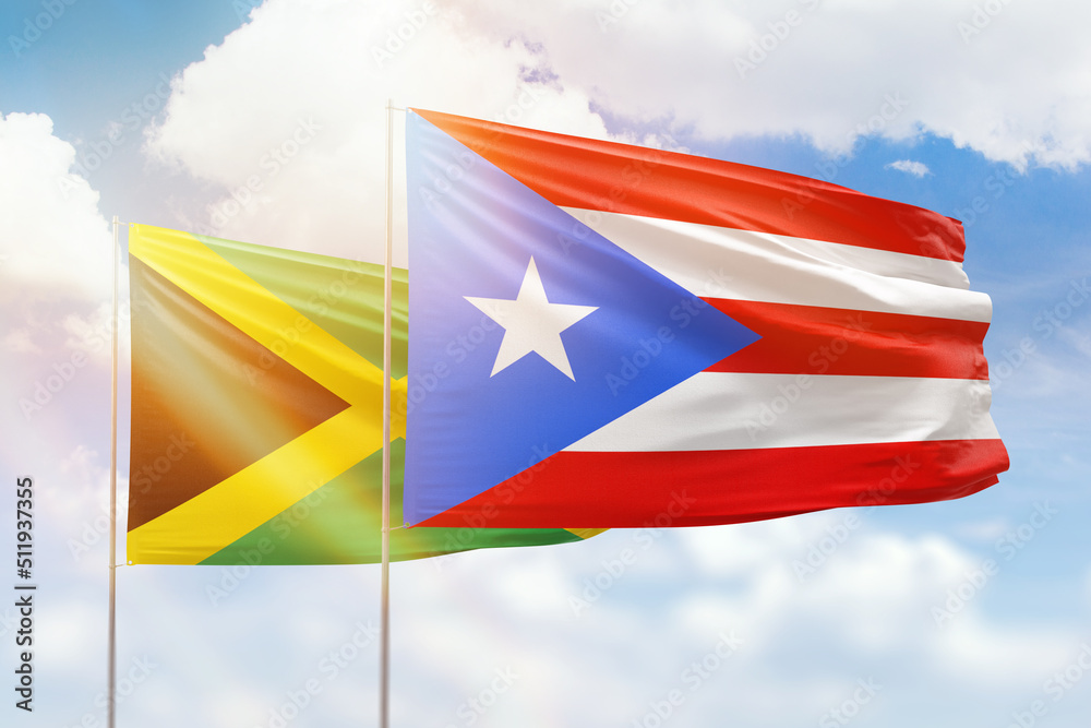 Sunny blue sky and flags of puerto rico and jamaica Sunny blue sky and flags of puerto rico and jamaica
