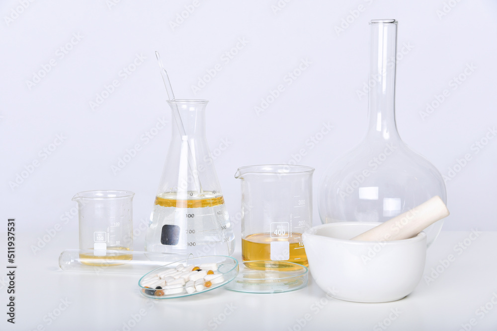 Pills and scientific laboratory glassware, Medicine research and development concept, Pharmaceutical quality control test. Pills and scientific laboratory glassware, Medicine research and development concept, Pharmaceutical quality control test.