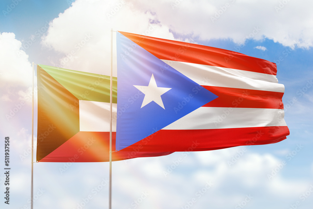 Sunny blue sky and flags of puerto rico and kuwait Sunny blue sky and flags of puerto rico and kuwait