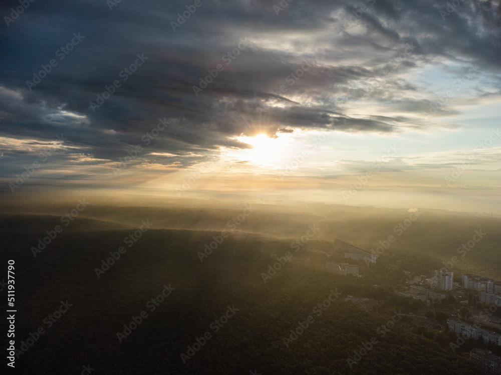 Peaceful sunrise in clouds view in green city residential district. Aerial morning forest near Kharkiv Ukraine. Morning skyscape, cloudscape and streets