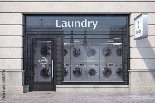 Laundry building exterior with washing machines inside it. photo