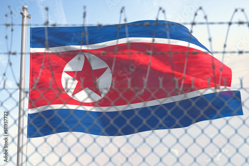 Flag of Nothern Korea behind barbed wire fence. Concept of sanctions, embargo, dictatorship, discrimination and violation of human rights and freedom in Nothern Korea.