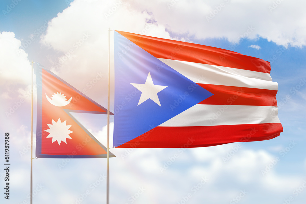 Sunny blue sky and flags of puerto rico and nepal Sunny blue sky and flags of puerto rico and nepal