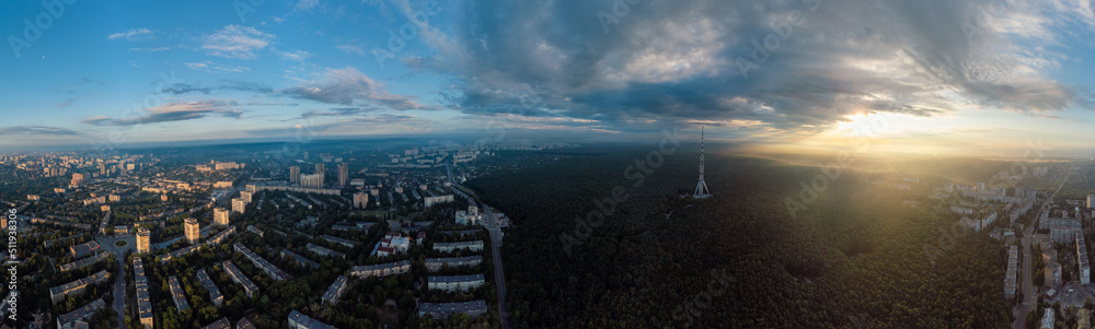 Sunrise cloudscape panorama view in city residential district. Aerial Pavlovo Pole, Kharkiv, Ukraine. Morning skyscape, cloudscape and streets