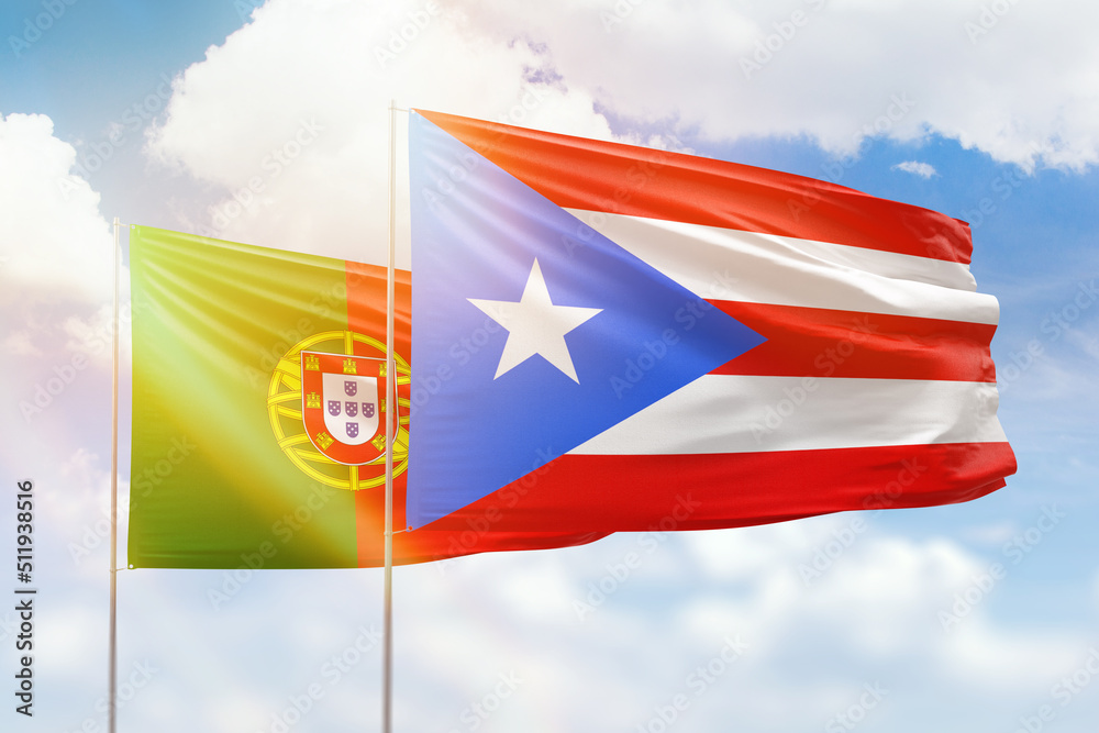 Sunny blue sky and flags of puerto rico and portugal Sunny blue sky and flags of puerto rico and portugal