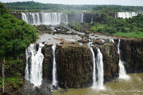 The photo shows a beautiful view of the Iguazu Falls  which are located on the border between Brazil and Argentina.