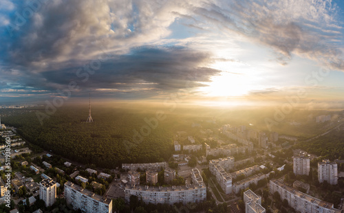 Sunrise bright panorama view in city residential district. Aerial Pavlovo Pole  Kharkiv  Ukraine. Morning sunny skyscape  cloudscape and streets