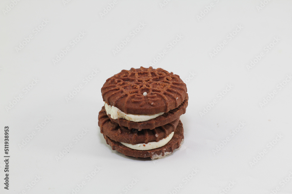 Chocolate biscuits covered with sugar cream, photo on a white background Chocolate biscuits covered with sugar cream, photo on a white background
