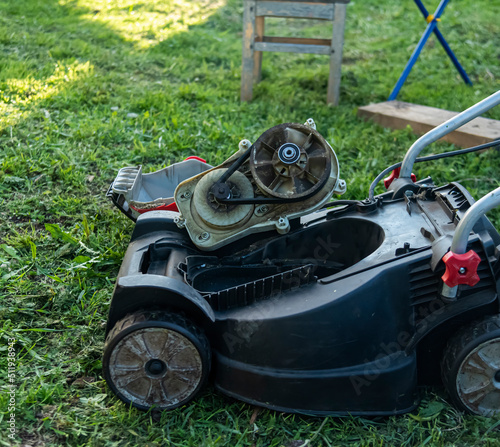 repair of a lawn mower by a gardener in a country house