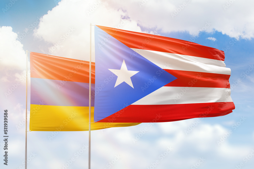 Sunny blue sky and flags of puerto rico and armenia Sunny blue sky and flags of puerto rico and armenia