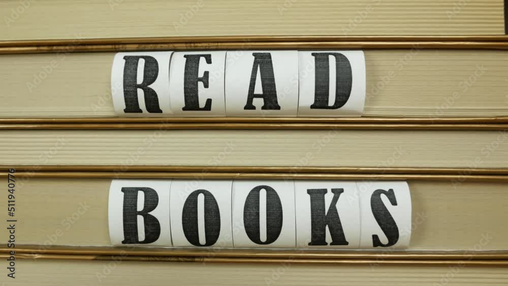 Bookshelf with books and inscription Read Books. Close up, dolly shot Bookshelf with books and inscription Read Books. Close up, dolly shot