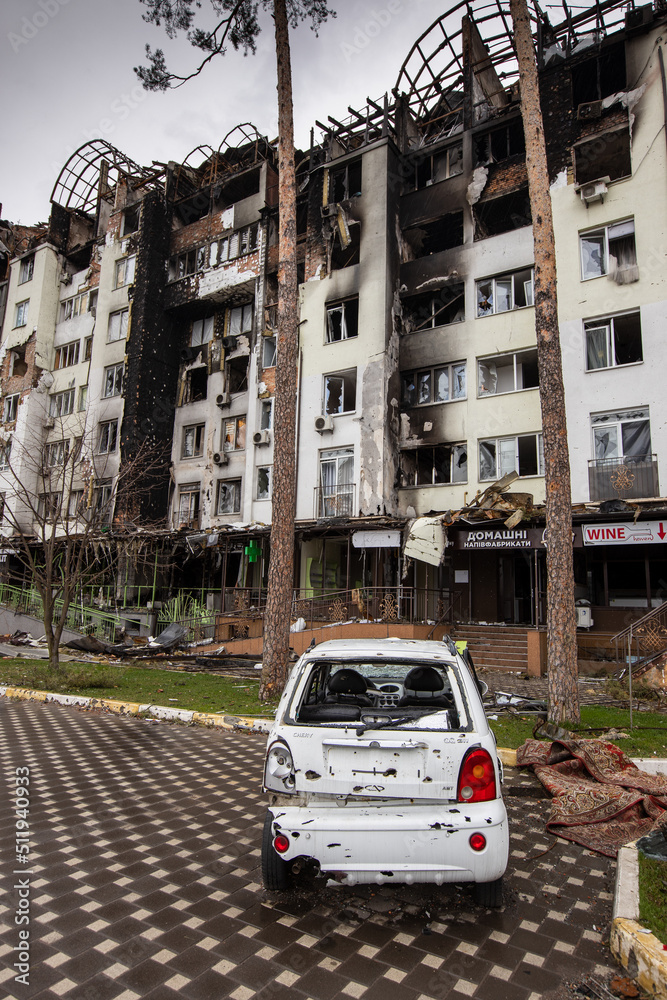 Shot cars. On the streets of Irpin. Cities of Ukraine after the Russian occupation. Irpin, Bucha, Hostomel. Destroyed and burnt houses in the background. Shot cars. On the streets of Irpin. Cities of Ukraine after the Russian occupation. Irpin, Bucha, Hostomel. Destroyed and burnt houses in the background.