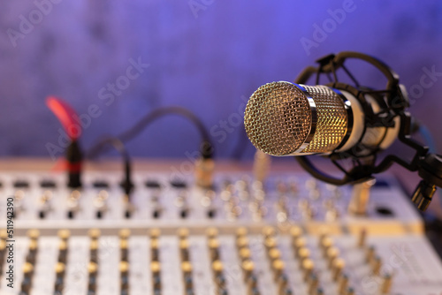 Microphone and sound mixer on desk table. Music audio concept in sound record studio © Svitlana