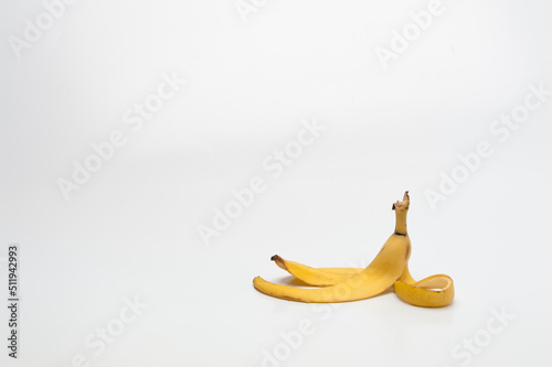 banana peel lying on a white floor photo