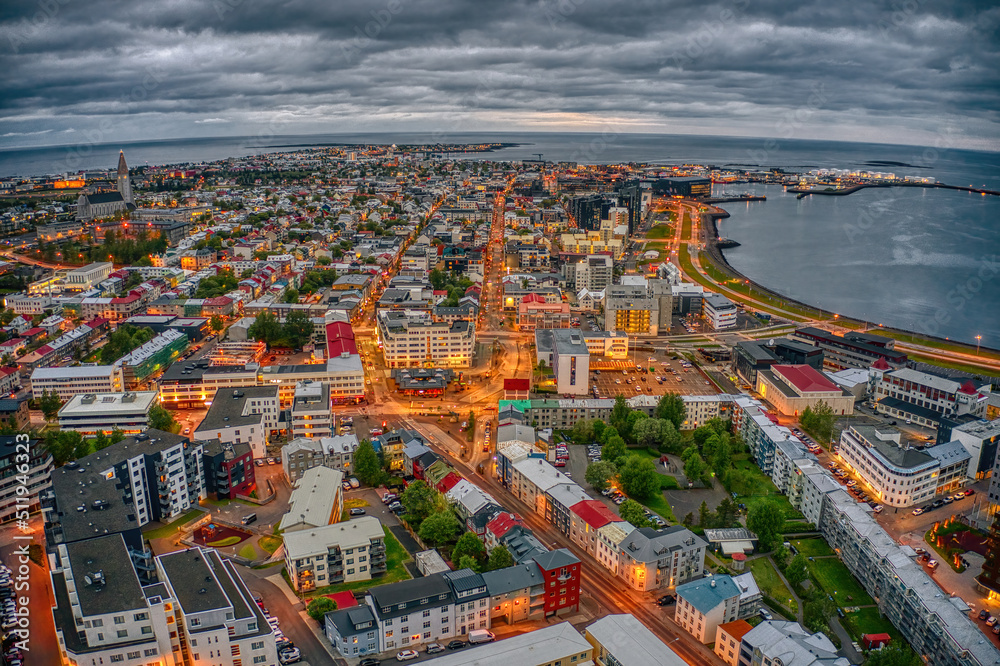 Obraz premium Aerial View of the rapidly growing Urban Center of Reykjavik, Iceland at Night during Summer