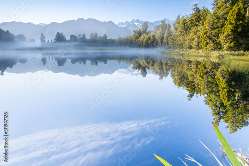 Obraz na plátně Perfect reflection in Lake Matheson surrounded by beautiful natural forest under