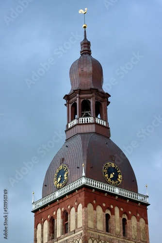 Tower of Riga Dome cathedral, Latvia, on a cloudy day with blue sky. Selective focus, vertical photo.