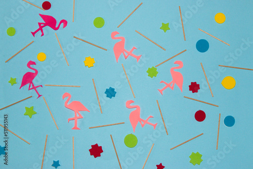 creative summer background, pastel blue with wooden sticks, colorful geometric shapes and pink flamingos, creative art tropical design