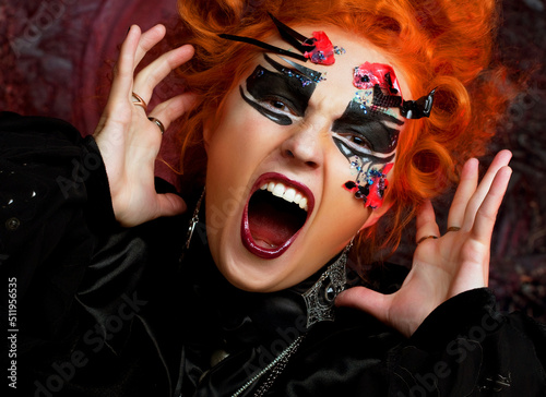 Fotografia Young redhead woman in witch costume screams and rages