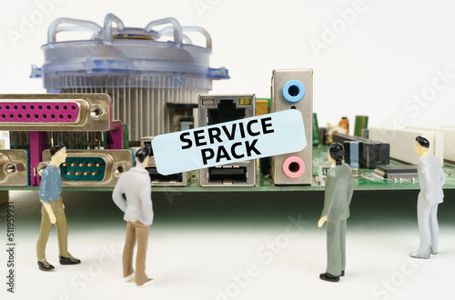 Figures of people are standing near the motherboard and looking at the sticker with the inscription - Service Pack