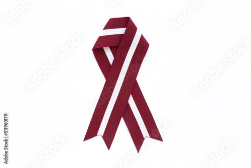 Ribbon in the colours of Latvian flag isolated on a white background.