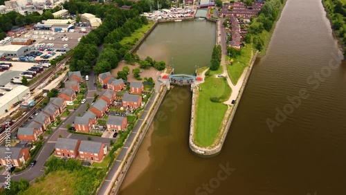 Aerial gimbal reveal clip of the bullnose entrance to Preston Marina and Docks from the River Ribble Lancashire England photo
