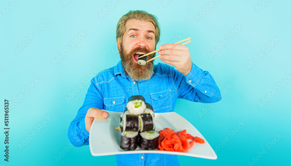 custom made wallpaper toronto digitalBearded man eating sushi with chopsticks. Japanese food delivery. Pickled ginger and sushi on plate.