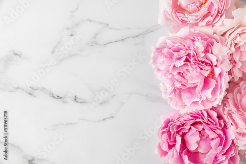 Fototapeta Naklejka Na Ścianę i Meble -  Flower composition. Pink peony flowers on white marble background. Flat lay. Top view with copy space