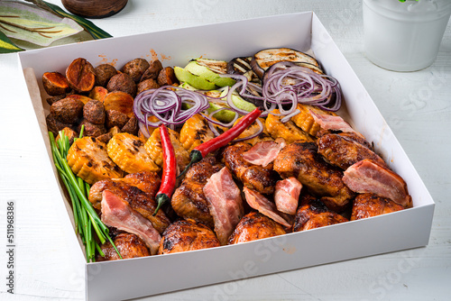 Steakhouse menu. Closeup of smoked meat, poultry assortment, baked Bonduelle corn. photo