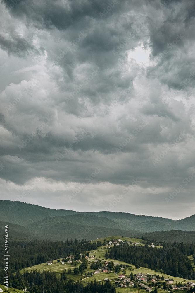 Obraz premium The rain starts in the mountains. Dark rain clouds covered the sky in Goah in summer.