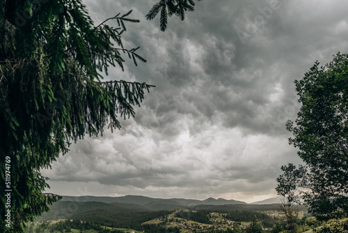 The rain starts in the mountains. Dark rain clouds covered the sky in Goah in summer. photo